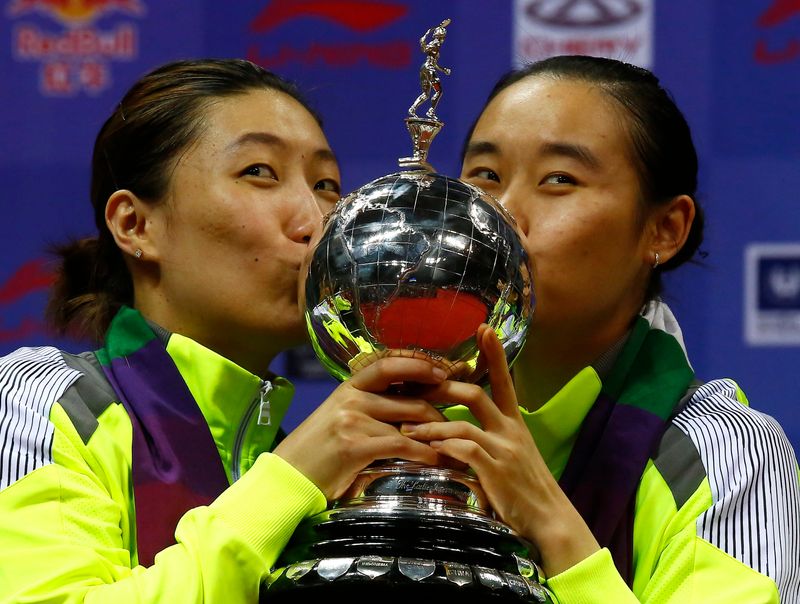 FILE PHOTO: China's Zhao and Wang kiss their trophy after winning their women's doubles final match against Japan's Maeda and Kakiiwa in the Uber Cup badminton championship in New Delhi