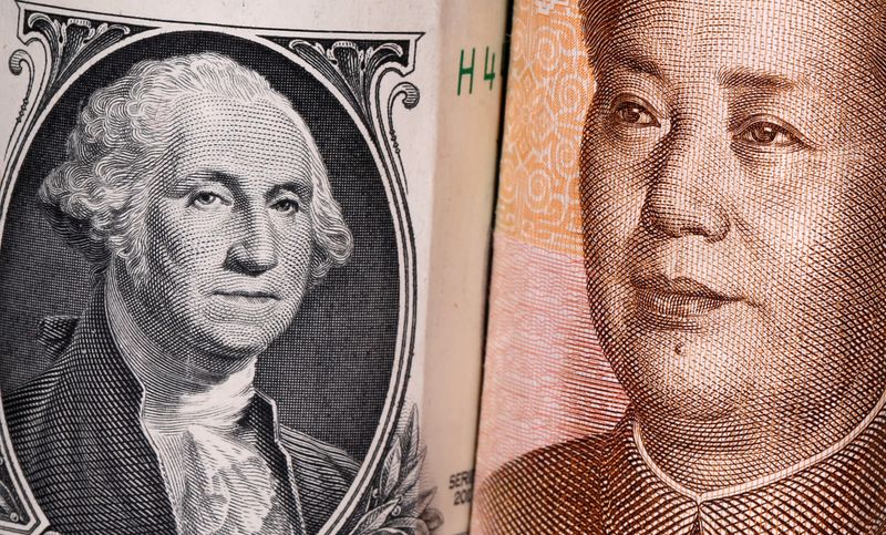 Chinese Yuan and U.S. dollar banknotes are seen in this illustration