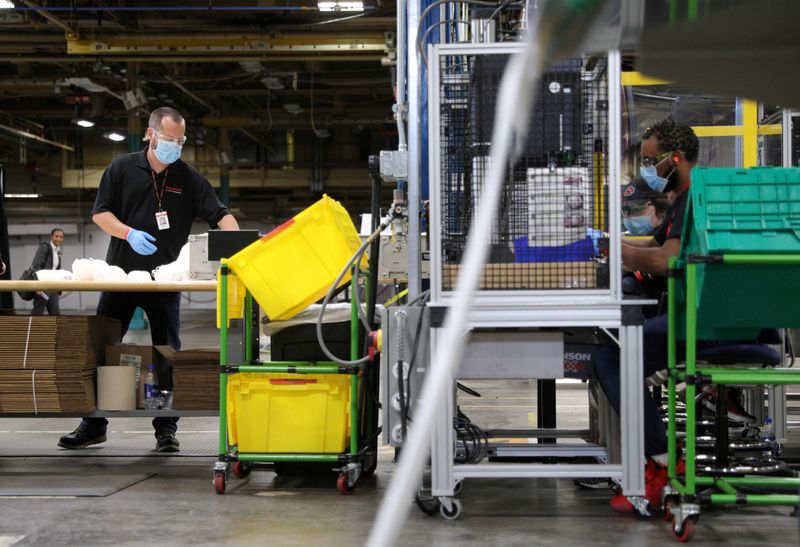 FILE PHOTO: Workers make protective face masks as U.S. President Donald Trump visits Honeywell plant in Phoenix, Arizona