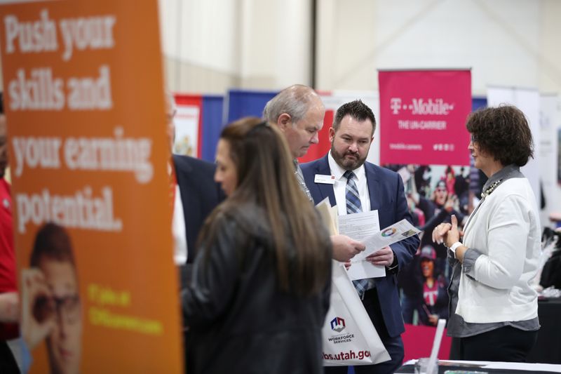 Veterans and military personnel discuss job opportunities at a military job fair in Sandy, Utah