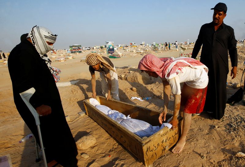 Iraqis flock to Najaf's COVID-19 cemetery to move their dead elsewhere