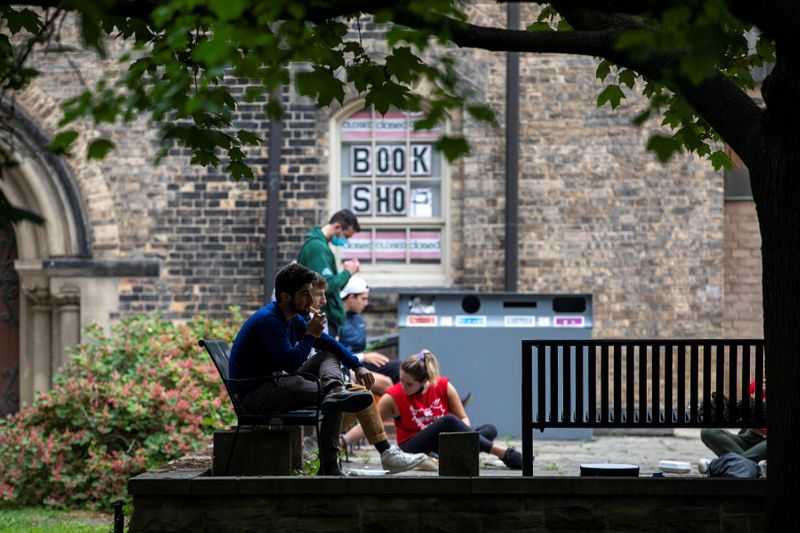 Students walk on the grounds of the University of Toronto in Toronto