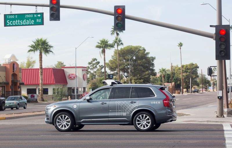 FILE PHOTO: A self driving Volvo vehicle, purchased by Uber, moves through an intersection in Scottsdale, Arizona,