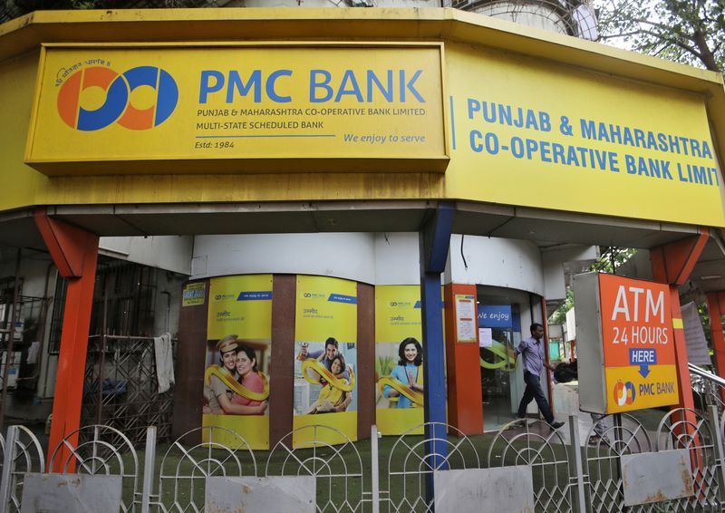 FILE PHOTO: A man walks out from a Punjab and Maharashtra Co-operative Bank branch in Mumbai
