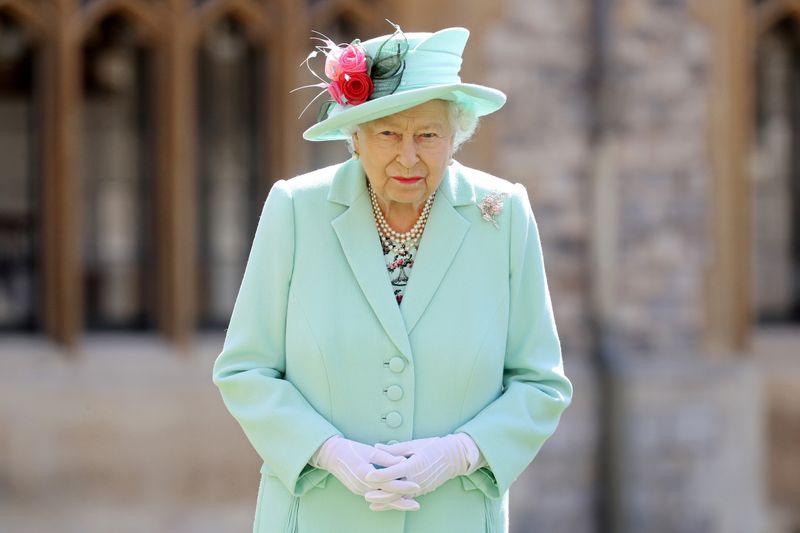 FILE PHOTO: Fundraising UK veteran Captain Tom receives knighthood from Britain's Queen Elizabeth at Windsor Castle