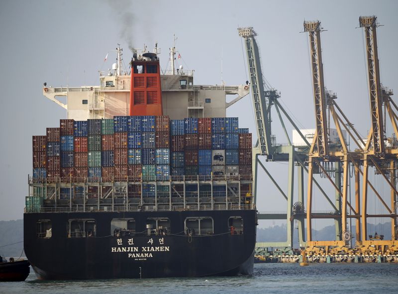 A ship prepares to dock at PSA's Tanjong Pagar container port in Singapore