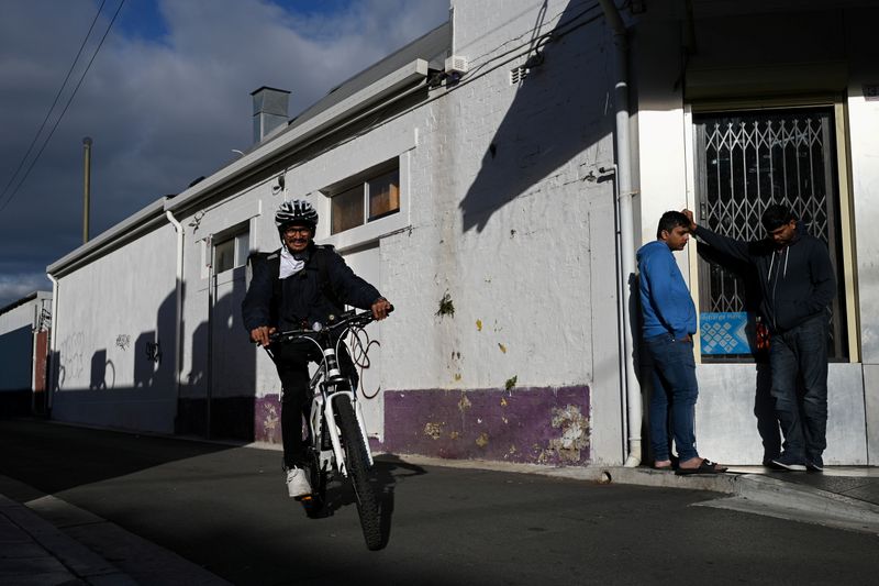 FILE PHOTO: An international student from India works as an Uber Eats bicycle courier in Sydney