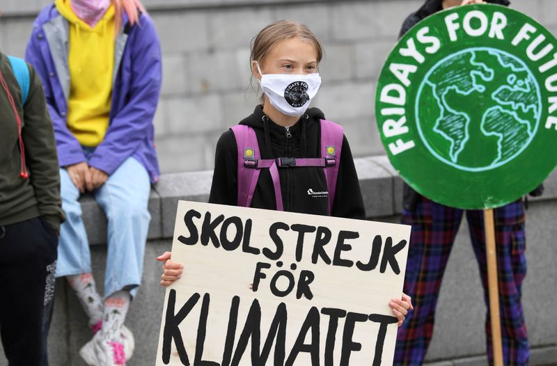FILE PHOTO: Swedish climate activist Greta Thunberg holds a poster reading