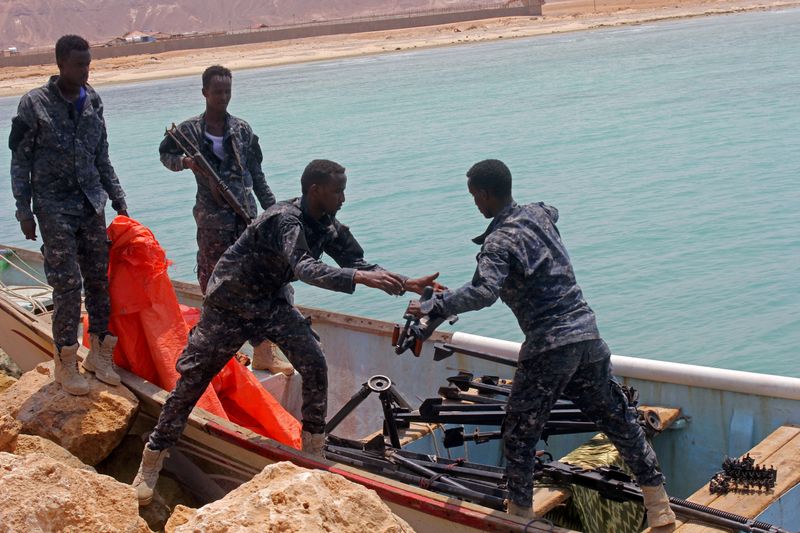 FILE PHOTO: Somali Puntland forces receive weapons seized in a boat on the shores of the Gulf of Aden in the city of Bosasso