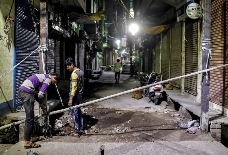 Muslims erect a barricade in a lane following Hindu-Muslim clashes triggered by a new citizenship law, in Kardam Puri in the riot-affected northeast of New Delhi