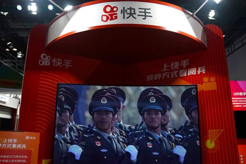 FILE PHOTO: A screen showing footage of a military parade is seen at a booth of Chinese video-streaming startup Kuaishou at the 2020 China International Fair for Trade in Services