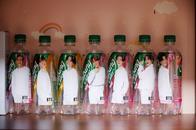 Empty soda bottles depicting members of BTS are placed on display at fan's room in Seoul