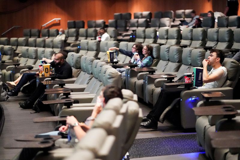 FILE PHOTO: People take their seats inside the Odeon Luxe Leicester Square cinema, on the opening day of the film