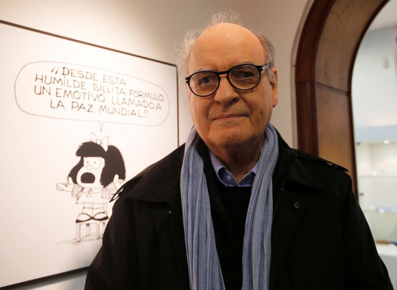 FILE PHOTO: Argentine cartoonist Quino poses in front of his most famous comic character Mafalda during the opening ceremony of the exhibition of his works at the Museo del Humor in Buenos Aires
