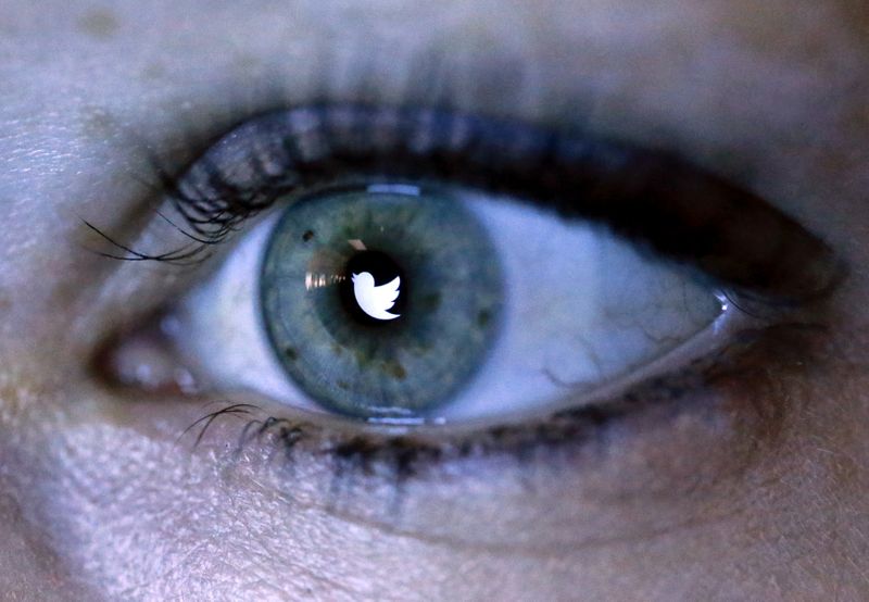 An illustration picture shows the Twitter logo reflected in the eye of a woman in Berlin