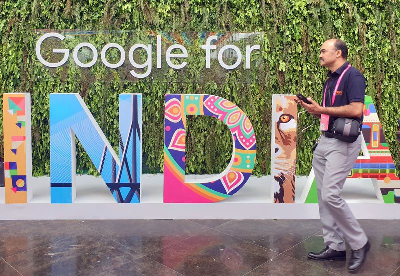 FILE PHOTO: A man walks past the sign of