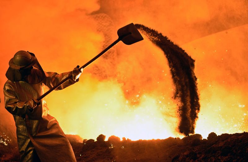 FILE PHOTO: A steel-worker is pictured at a furnace at the plant of German steel company Salzgitter AG in Salzgitter.