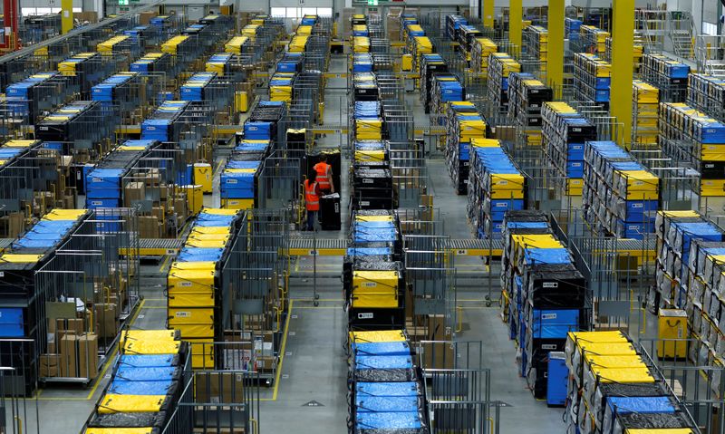 FILE PHOTO: Employees handle packages at an Amazon logistic center in Mannheim