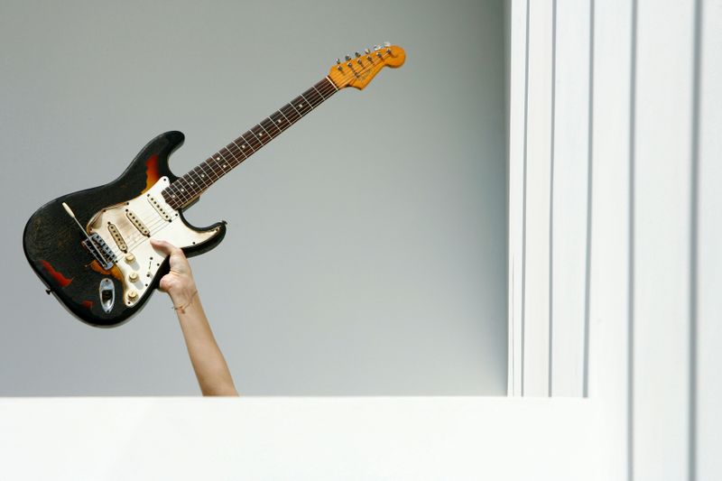 FILE PHOTO: A 1965 Fender Stratocaster guitar belonging to Jimi Hendrix is held up during a photocall at the Idea Generation Gallery in London