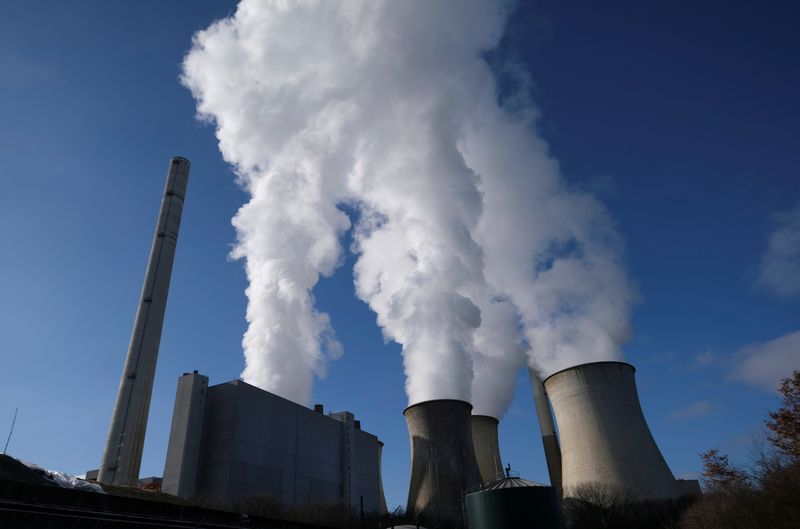 FILE PHOTO: Steam rises from the cooling towers of the lignite power plant complex of German energy supplier and utility RWE in Neurath