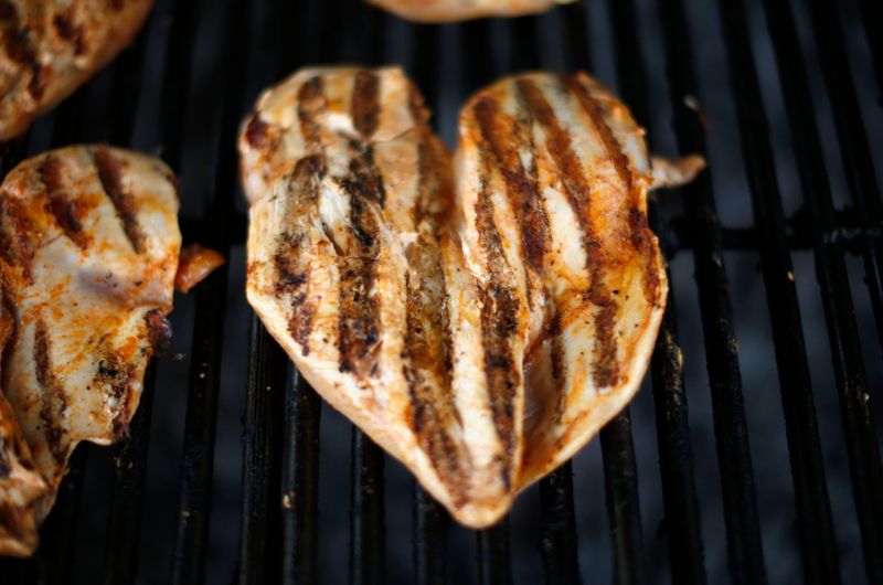 Pieces of chicken are seen on a grill at The Outdoor Grill in Culver City, Los Angeles