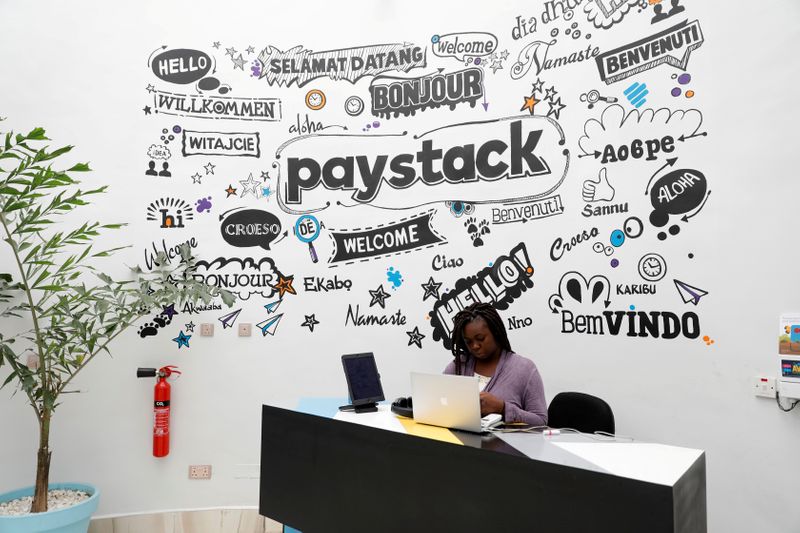 FILE PHOTO: A staff member works at the reception of the paystack online payment company in the government reserved area in Ikeja, in Lagos