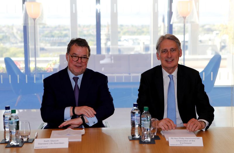 FILE PHOTO: Keith Skeoch CEO of Standard Life Aberdeen and Britain's Chancellor of the Exchequer Philip Hammond pose for a photograph in Edinburgh