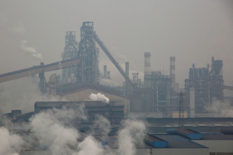FILE PHOTO: Smoke and steam rise from a steel plant in Anyang
