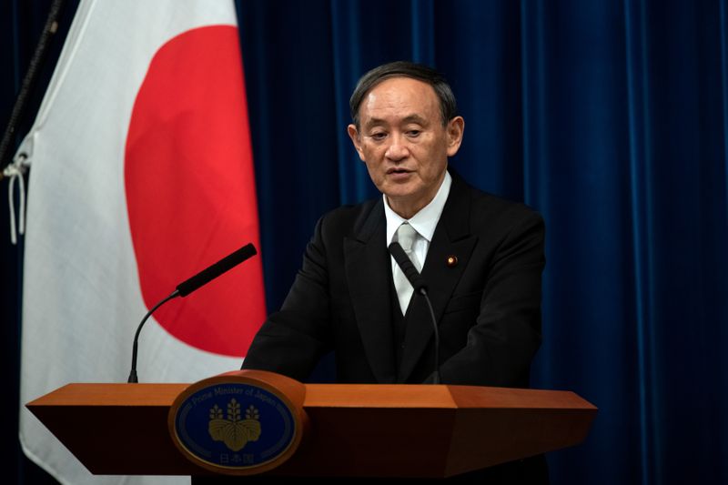 FILE PHOTO: Yoshihide Suga speaks during a news conference following his confirmation as Prime Minister of Japan in Tokyo