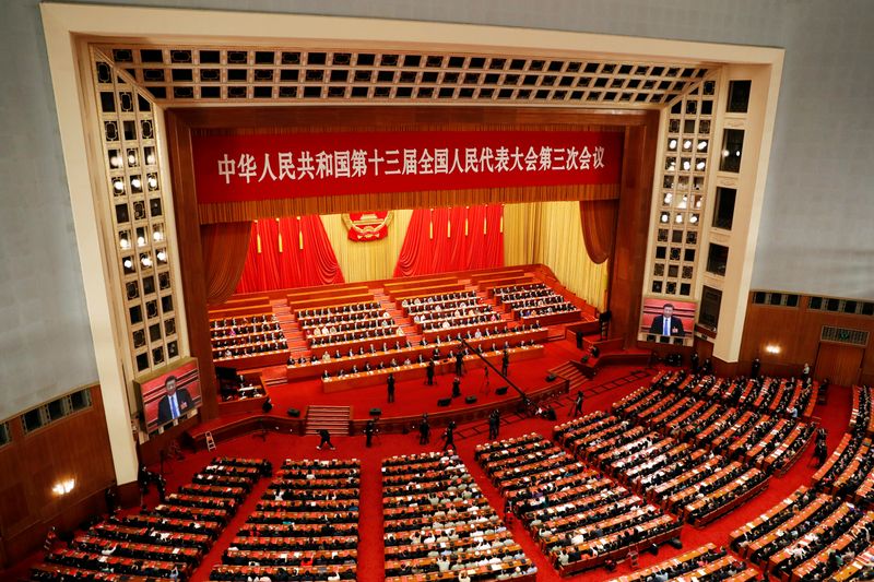 FILE PHOTO: Chinese officials and delegates attend the closing session of NPC in Beijing