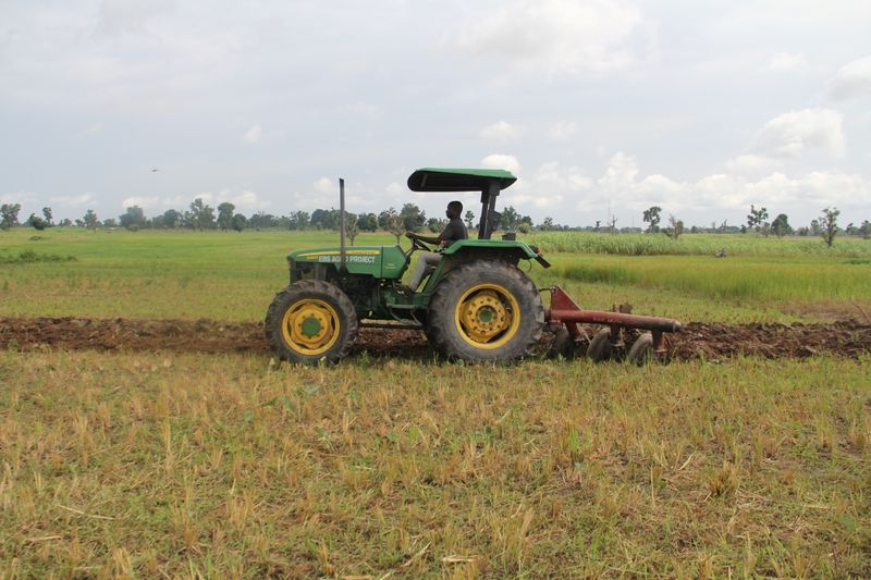 A farmer drives a tractor provided by Alluvial Agriculture along a field in Nasarawa state