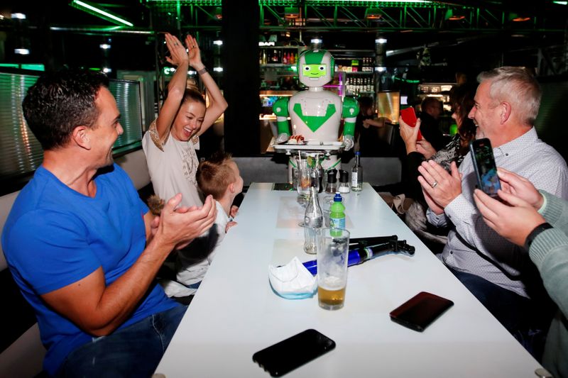 FILE PHOTO: A robot delivers a birthday cake at Robotazia restaurant as the coronavirus disease (COVID-19) outbreak continues in Milton Keyne