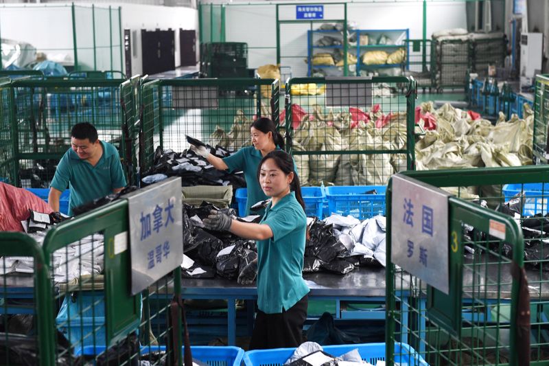 Workers sort international parcels at a cross-border e-commerce industrial park ahead of the Singles Day online shopping festival in Hefei