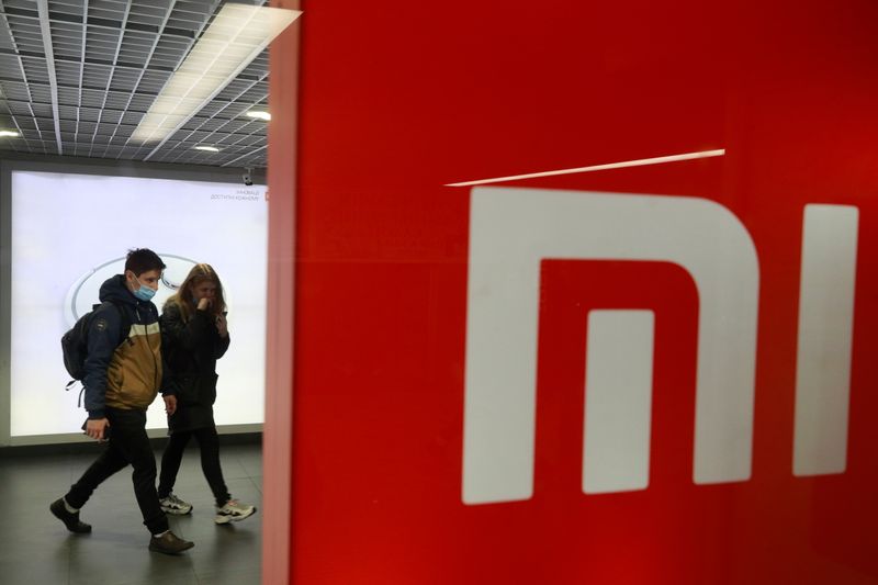 People wearing protective face masks visit Xiaomi brand's store in Kyiv