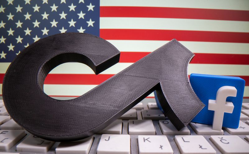 FILE PHOTO: A 3D printed Tik Tok and Facebook logo are placed on a keyboard in front of U.S. flag in this illustration
