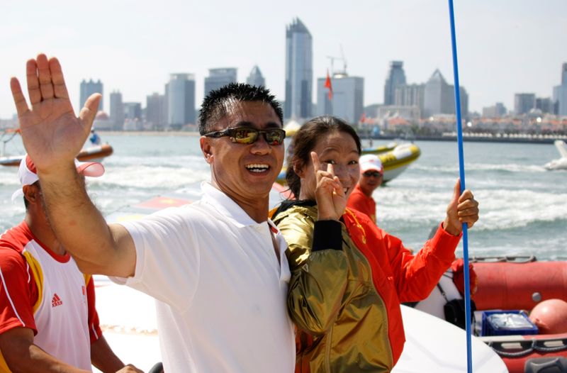 Vice President of Chinese Yachting Association Li Quanhai hugs Yin Jian of China, sailing in RS:X Women, after she won gold at the Beijing 2008 Olympic Games in Qingdao