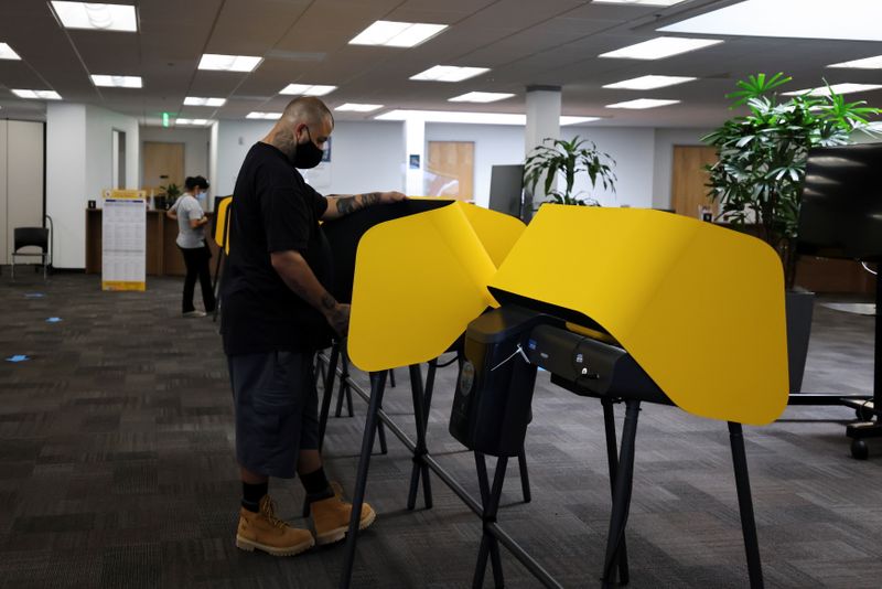 FILE PHOTO: Michael Gonzales, 35, votes at the Uber Hub polling station
