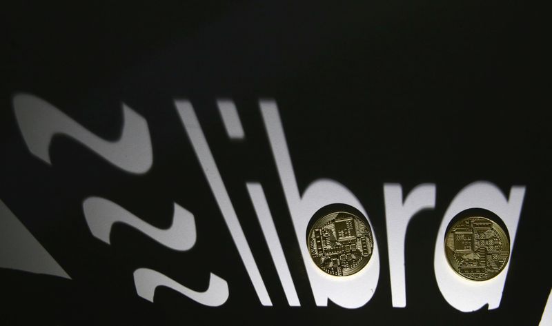 Shadow of a 3D-printed Facebook Libra cryptocurrency logo is seen near cryptocurrency representation in this illustration taken