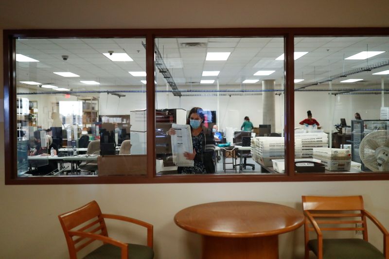 Employees work at the Maricopa County Elections ballot processing center in Phoenix