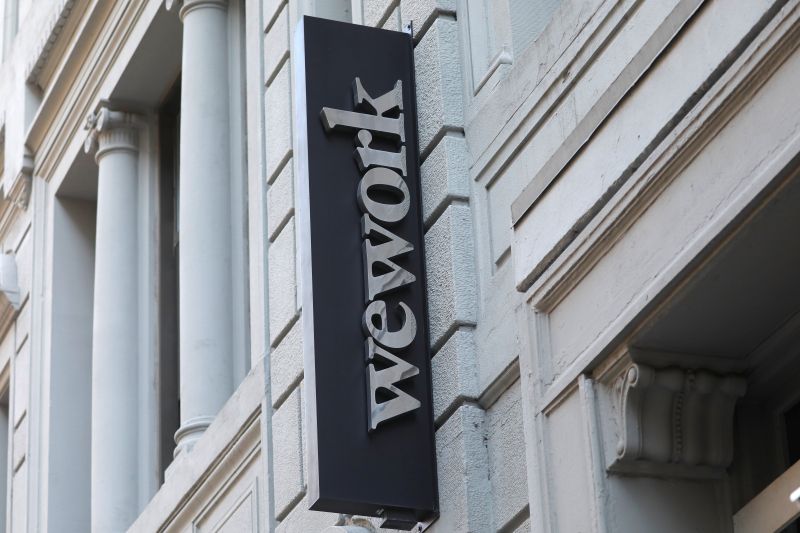 A sign is seen above the entrance to the WeWork corporate headquarters in Manhattan, New York