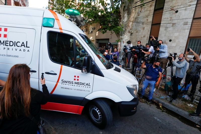 An ambulance carrying Diego Maradona leaves the clinic where Maradona underwent brain surgery, in Olivos