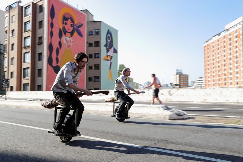 Vinicius Sanctus and Alessandro Russo ride electric monowheels called 'nuvem' (cloud) that were invented by them and inspired by the magic flying brooms of the Harry Potter series in Sao Paulo