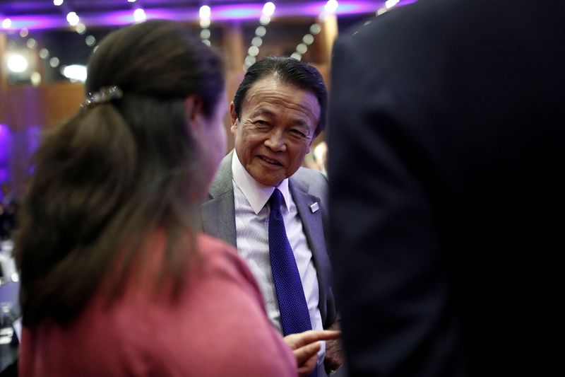 Japanese Finance Minister Taro Aso attends a high-level forum on debt at the Finance ministry in Paris