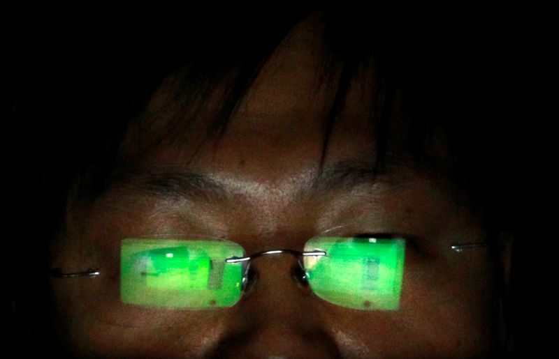 FILE PHOTO: A hacker works on his laptop in Taipei