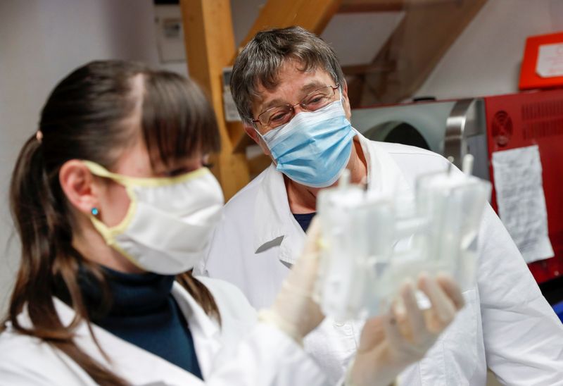 Hungarian biologists Torok and Lukacs check the purity of an antibody, in Szirak