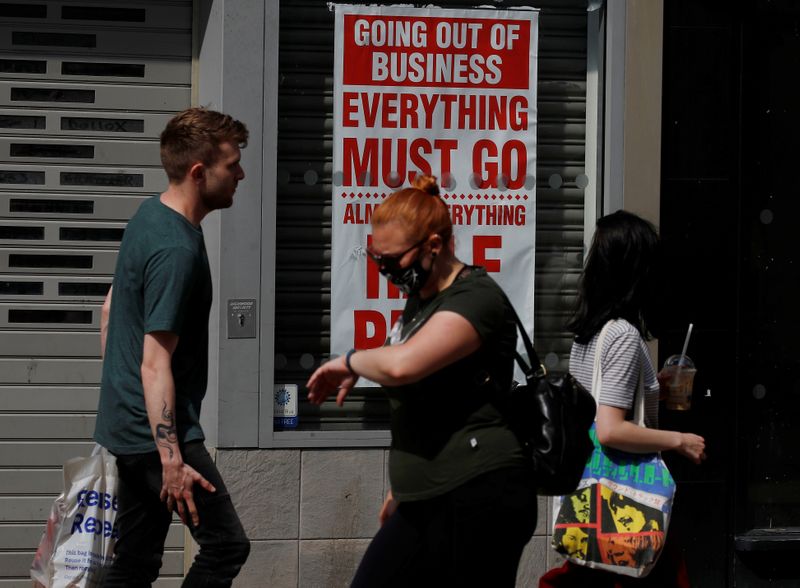 People walk past a closed shop following the outbreak of the coronavirus disease (COVID-19) in Chester, Britain
