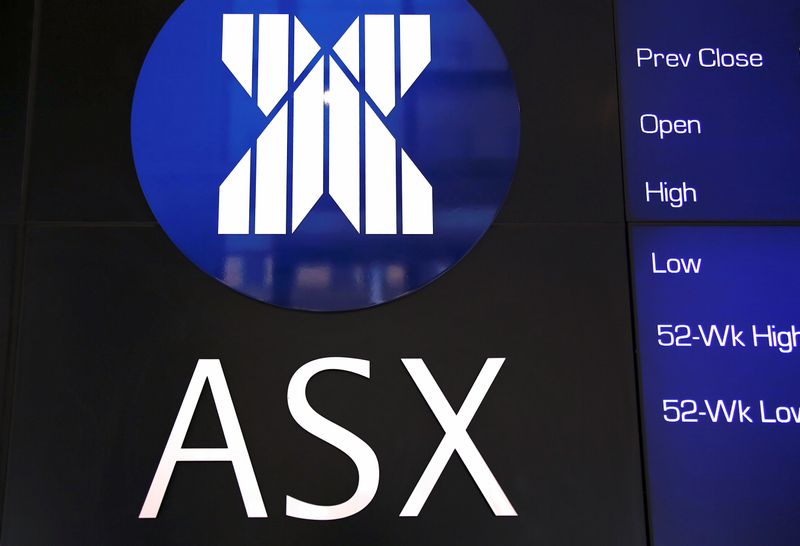 A board displaying stock prices is adorned with the Australian Securities Exchange (ASX) logo in central Sydney