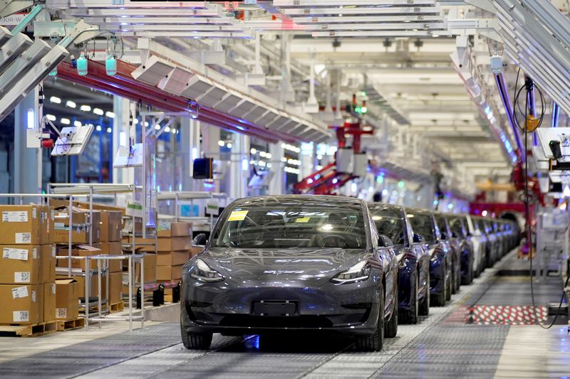 FILE PHOTO: FILE PHOTO: FILE PHOTO: Tesla China-made Model 3 vehicles are seen during a delivery event at its factory in Shanghai