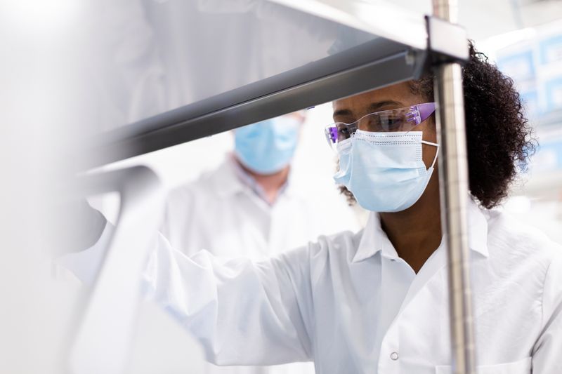 A researcher works in a lab run by Moderna