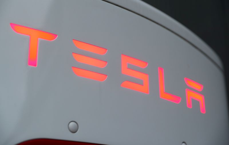 The logo of Tesla is seen at a Tesla Supercharger station in Dietikon